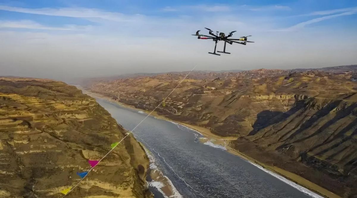 Drone flying along a river valley with a guide line